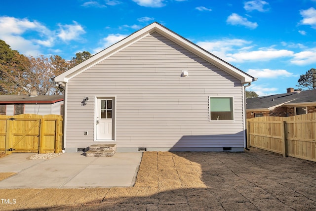 back of property with a patio