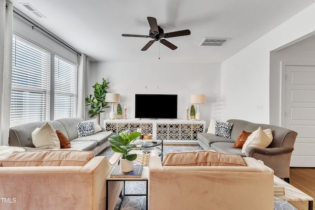 living room featuring ceiling fan and hardwood / wood-style flooring