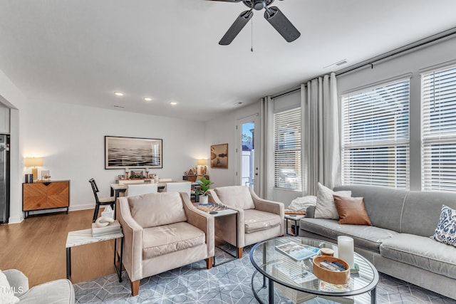 living room featuring ceiling fan and hardwood / wood-style floors