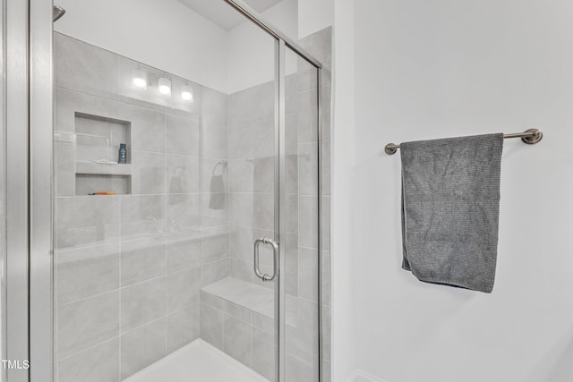 bathroom featuring a shower with shower door