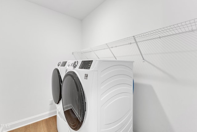 washroom featuring separate washer and dryer and wood-type flooring