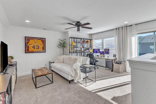 carpeted living room featuring ceiling fan