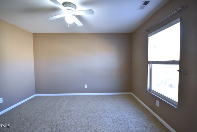 spare room with ceiling fan and carpet