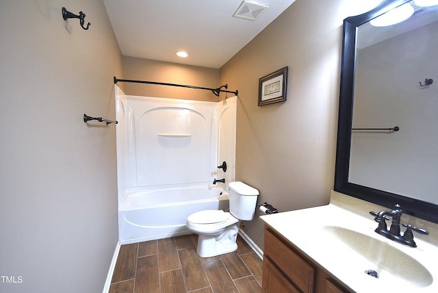 full bathroom with toilet, vanity, and washtub / shower combination