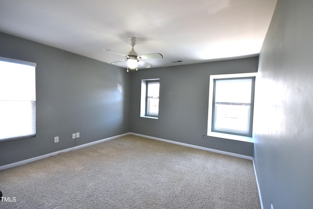 unfurnished room with ceiling fan, plenty of natural light, and carpet flooring