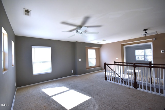 carpeted empty room with ceiling fan