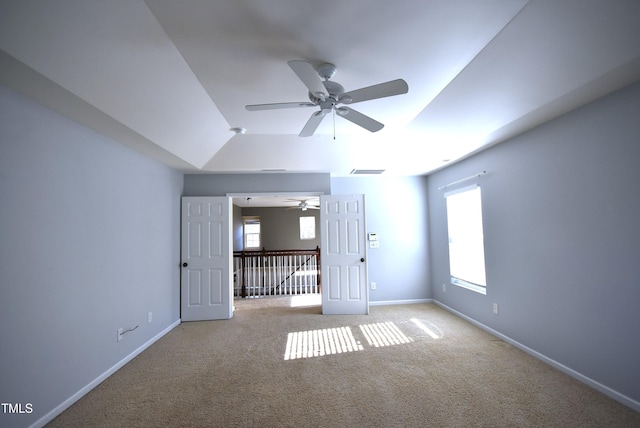 carpeted spare room with ceiling fan, plenty of natural light, and vaulted ceiling