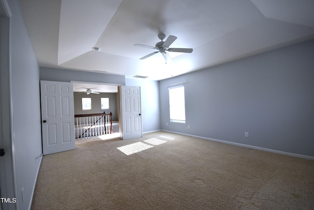 interior space featuring ceiling fan and a tray ceiling