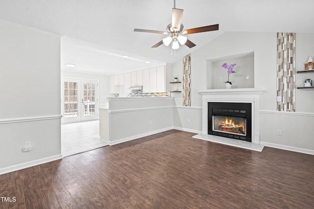 unfurnished living room featuring french doors, ceiling fan, lofted ceiling, and wood-type flooring