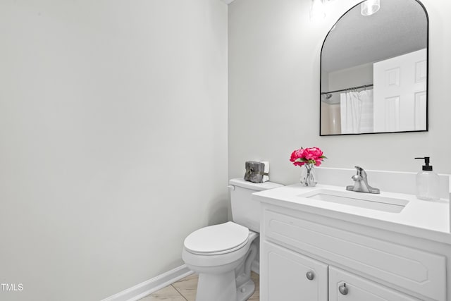 bathroom with curtained shower, toilet, vanity, and tile patterned flooring