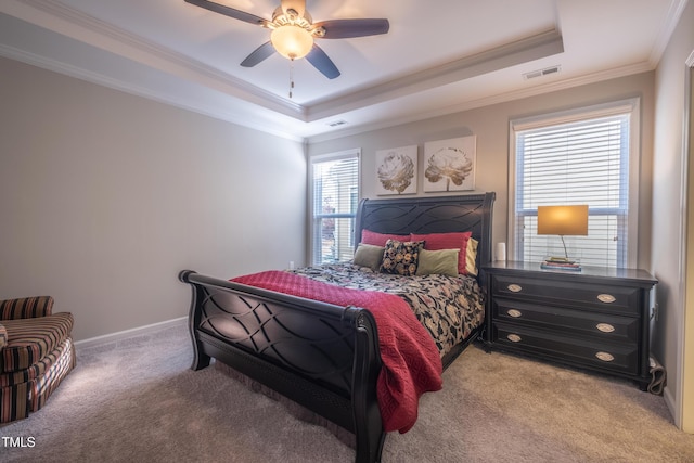 bedroom featuring a raised ceiling, ornamental molding, light carpet, and ceiling fan