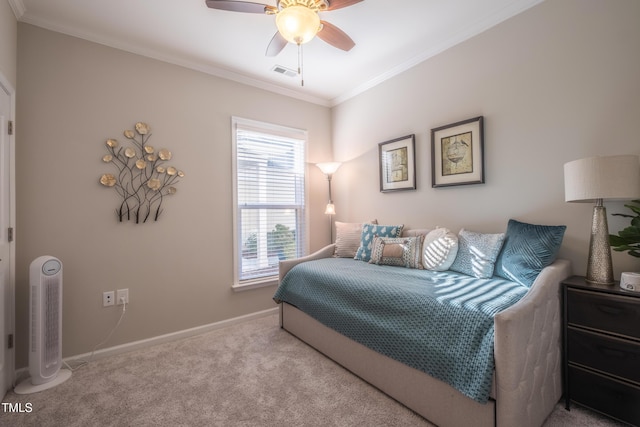 carpeted bedroom with ornamental molding and ceiling fan