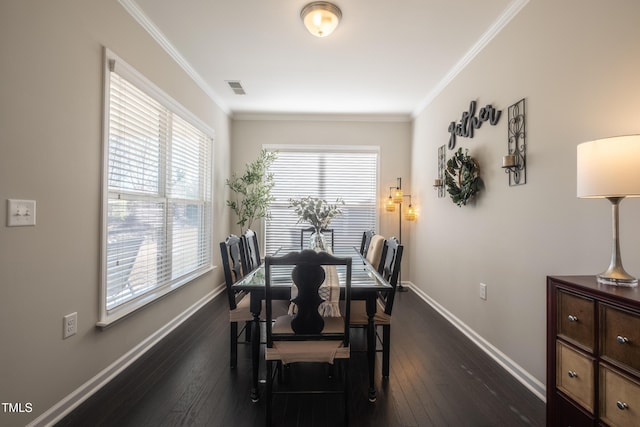 dining room with crown molding and dark hardwood / wood-style floors