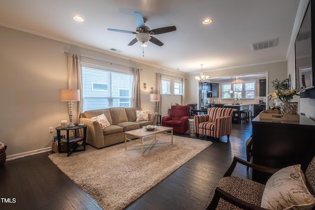 living room featuring ornamental molding, dark hardwood / wood-style flooring, and ceiling fan with notable chandelier