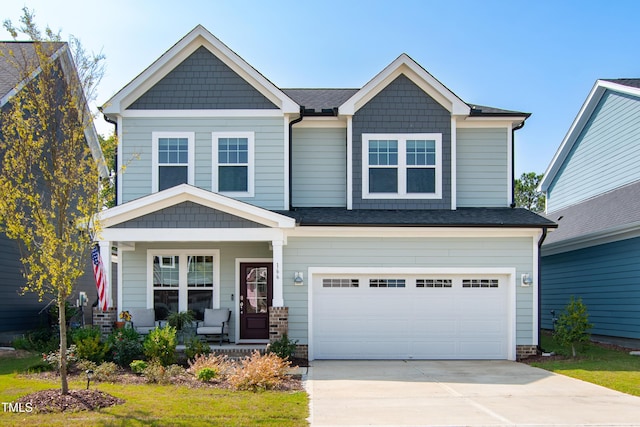 craftsman house with a garage and a porch