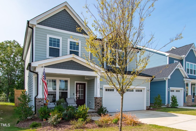 craftsman house with a garage and covered porch