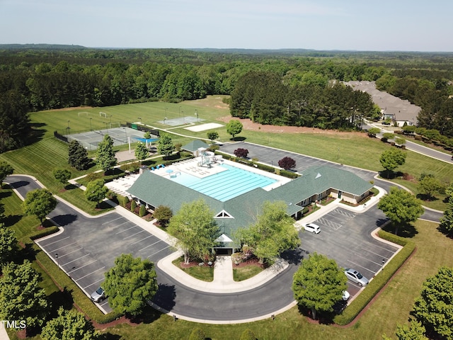 birds eye view of property featuring a view of trees