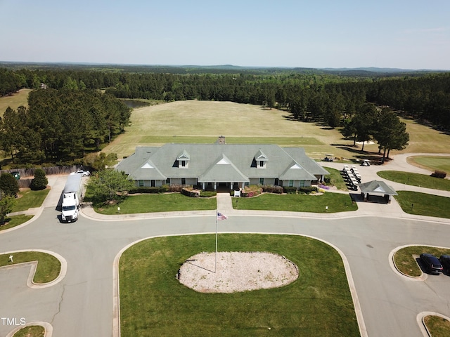 birds eye view of property featuring a wooded view