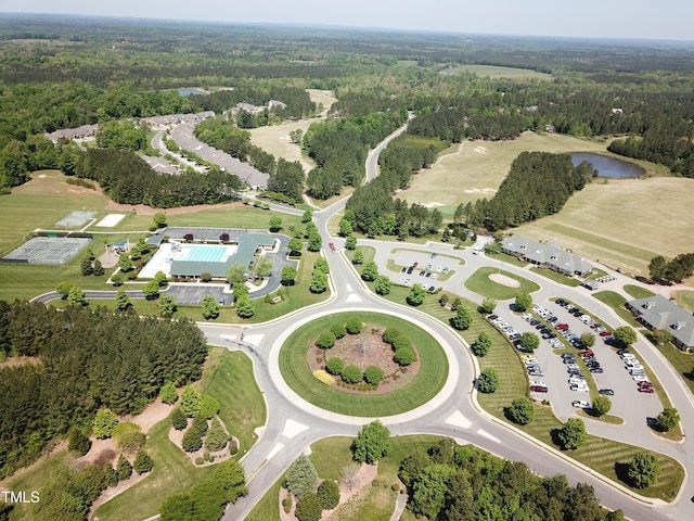 drone / aerial view with a water view and a wooded view