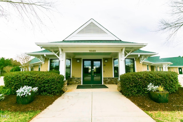 property entrance with a porch and french doors