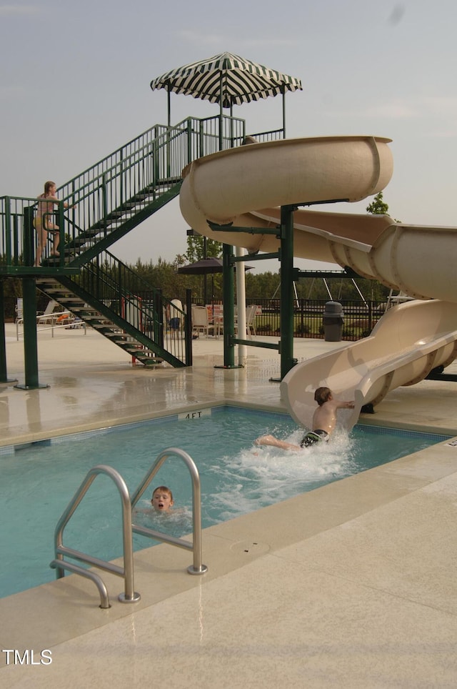 view of swimming pool featuring a water slide