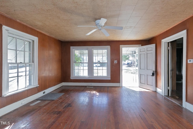 unfurnished sunroom with ceiling fan