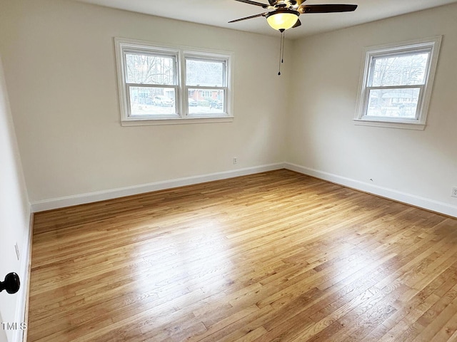 empty room with ceiling fan and light wood-type flooring