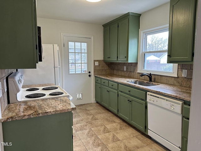 kitchen with sink, tasteful backsplash, plenty of natural light, green cabinets, and white appliances