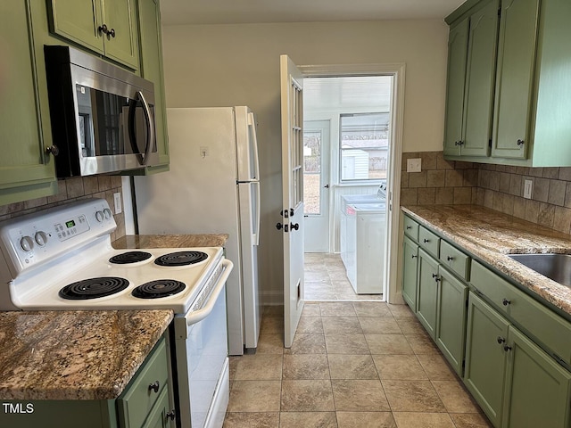 kitchen featuring green cabinetry and electric stove