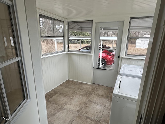 unfurnished sunroom featuring separate washer and dryer