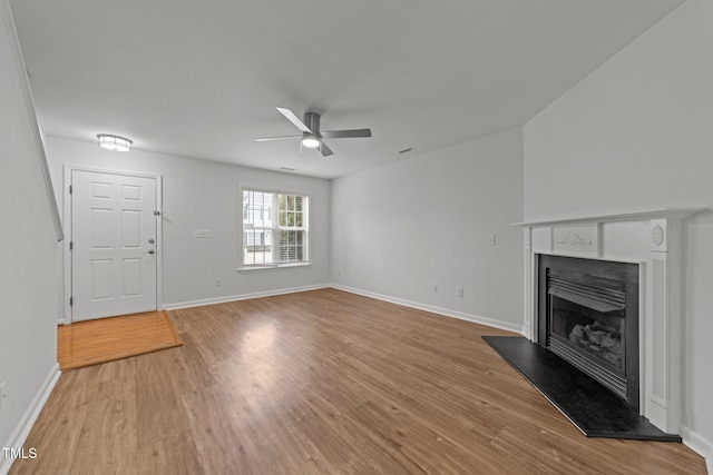 unfurnished living room featuring ceiling fan and light hardwood / wood-style floors