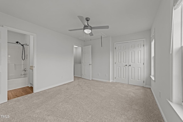 unfurnished bedroom featuring ceiling fan, connected bathroom, and light colored carpet