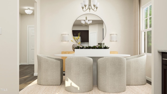 dining space featuring hardwood / wood-style flooring and a notable chandelier