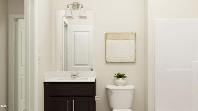 bathroom featuring toilet and vanity