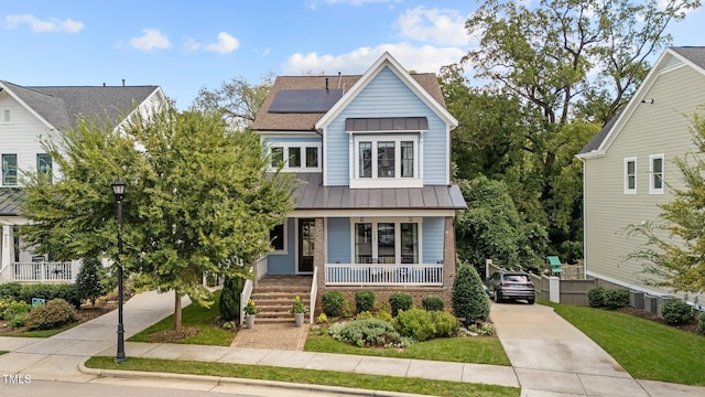 view of front facade with solar panels and a porch