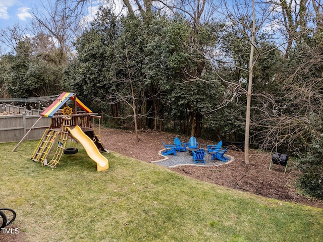 view of playground with a fire pit and a lawn