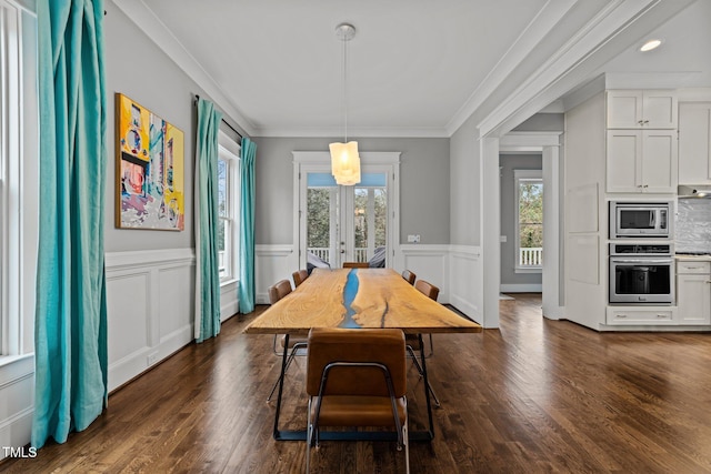 dining room featuring french doors, crown molding, dark wood-type flooring, and a wealth of natural light