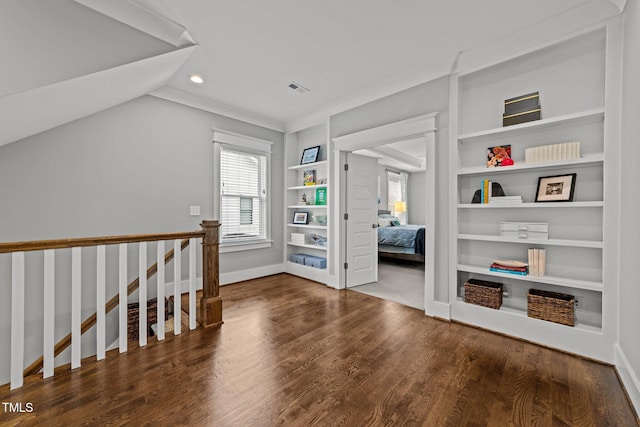 interior space with lofted ceiling, dark wood-type flooring, and built in features