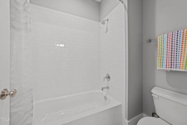 bathroom with shower / bath combination with curtain and toilet