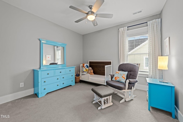 living area with ceiling fan and light colored carpet