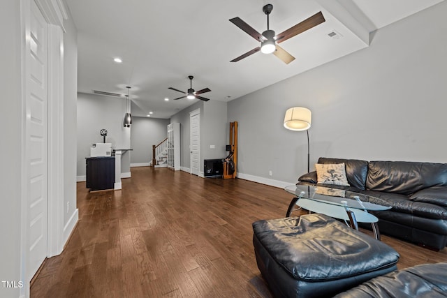 living room with dark wood-type flooring and ceiling fan