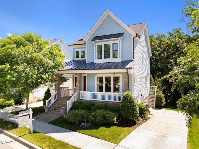 1000 Norris St, Raleigh, NC 27604 - view of front of home featuring a standing seam roof, a porch, stairs, and metal roof