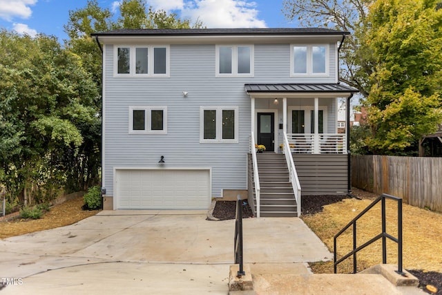 view of front of home featuring a porch and a garage