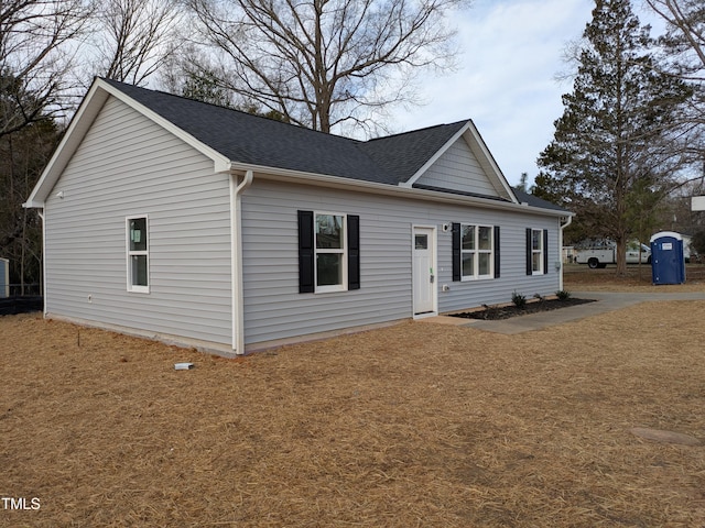 ranch-style house with roof with shingles