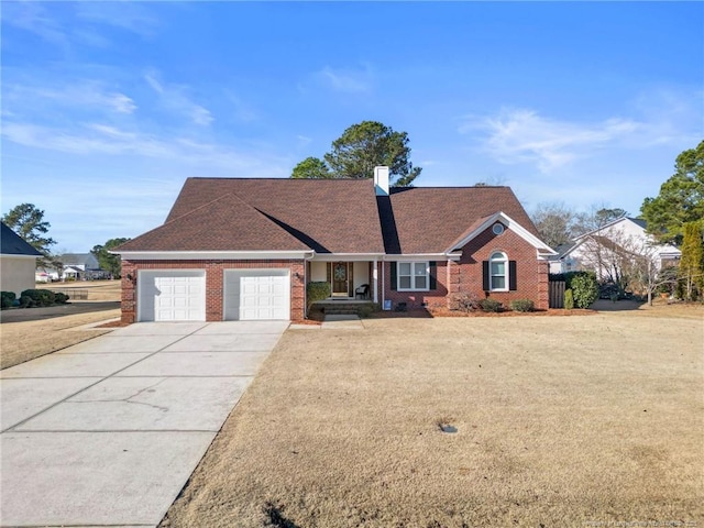 view of front of home with a front lawn and a garage