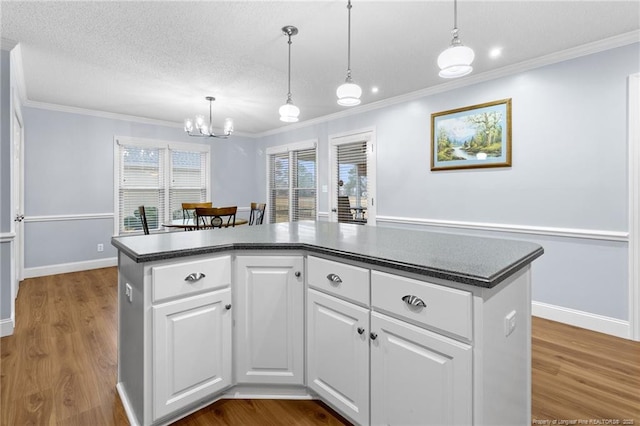 kitchen with wood-type flooring, white cabinets, and a center island