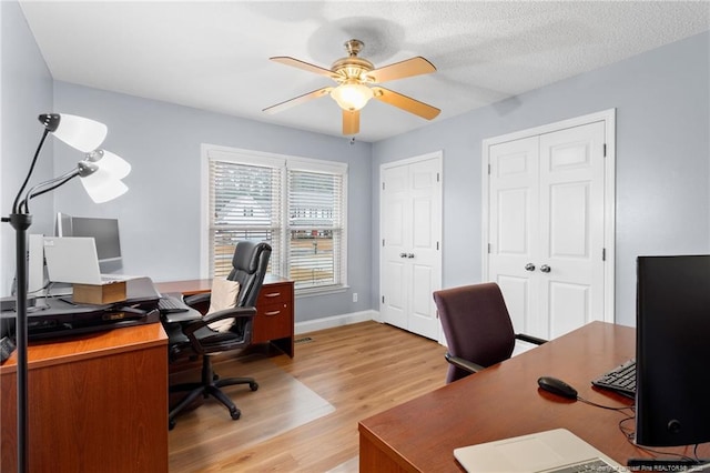 home office featuring ceiling fan, a textured ceiling, and light hardwood / wood-style flooring