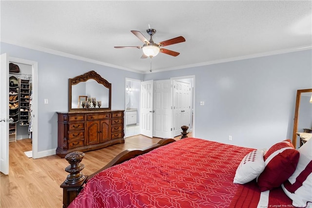 bedroom featuring ceiling fan, connected bathroom, wood-type flooring, and ornamental molding