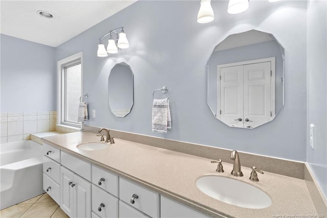 bathroom with vanity, a bath, and tile patterned flooring