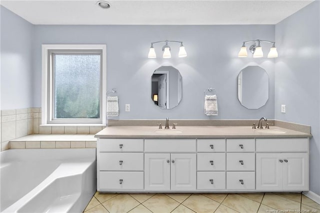 bathroom featuring tile patterned floors, vanity, a bathing tub, and a healthy amount of sunlight